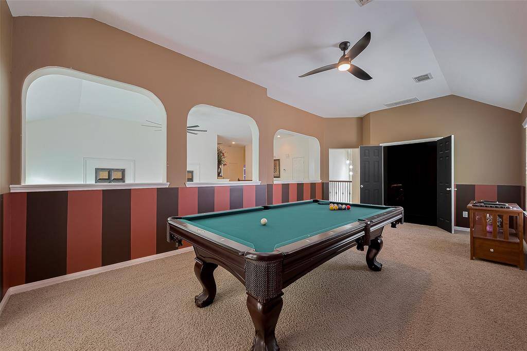 This angle of the game room looks toward the media room/theater. The half walls allow you to look down at the living room.