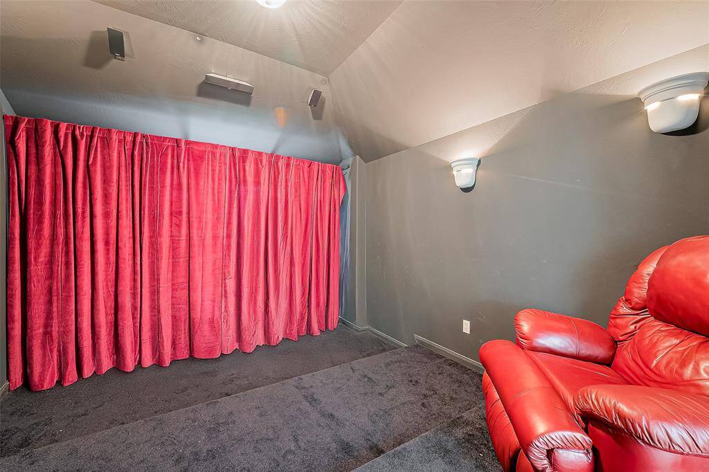 Spacious movie theater***There is currently a credenza in there that will be removed; it has been photoshopped out to showcase the full curtain.