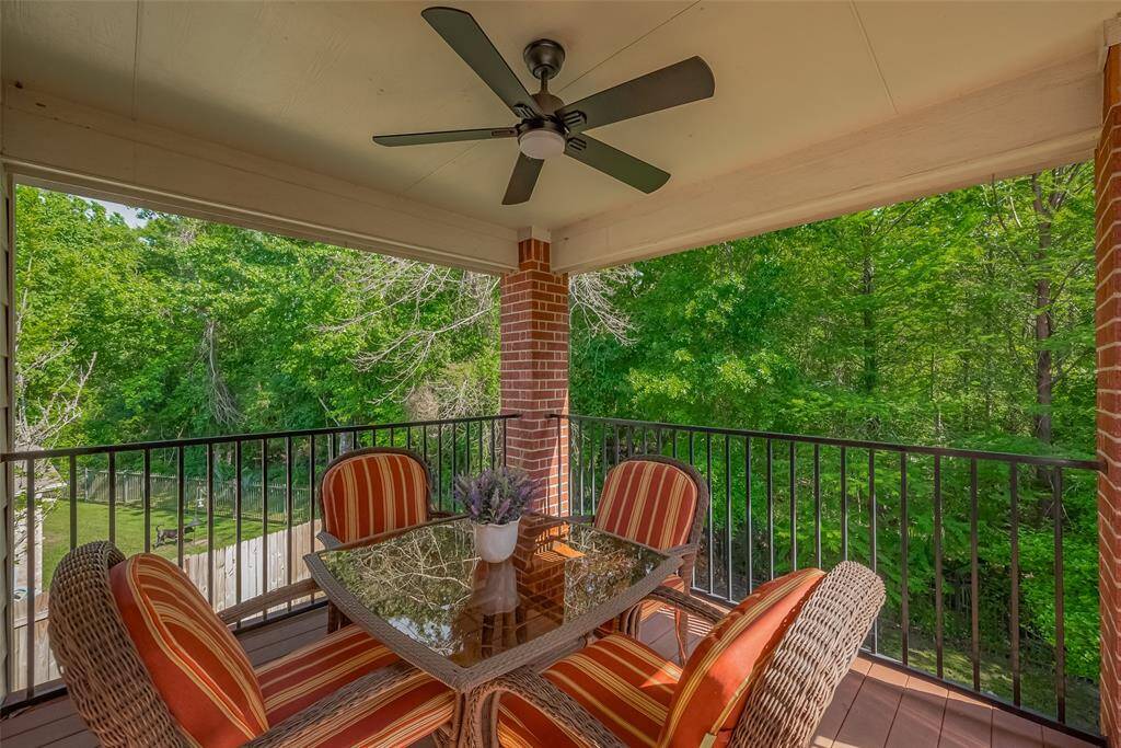 Upstairs balcony/covered patio with fan.