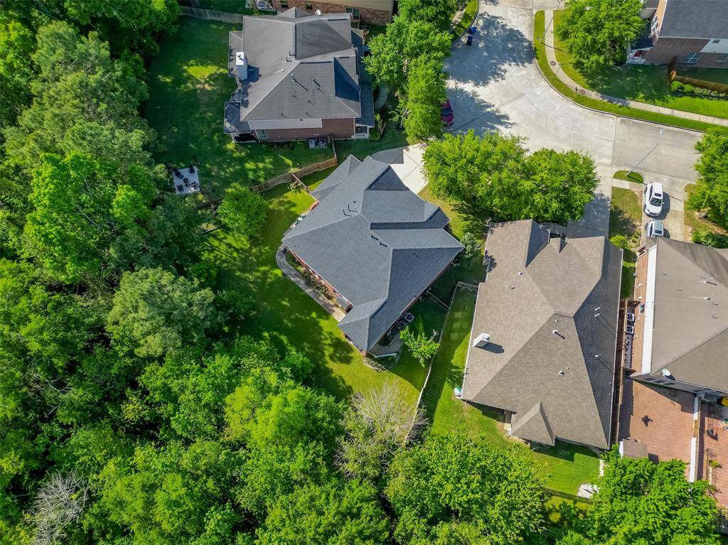 Aerial view of property to show no back neighbors and plenty of shade from mature trees.