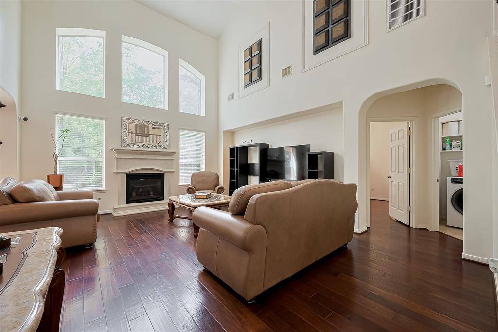 Gorgeous living room with fantastic natural lighting & high ceilings.