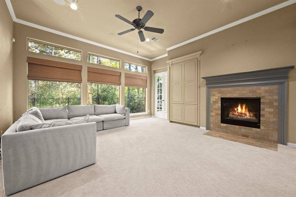 Living Room with inviting Fire Place for those cool mornings.  built-in entertainment cabinet has doors to completely close, for books, CD's and also space for a TV