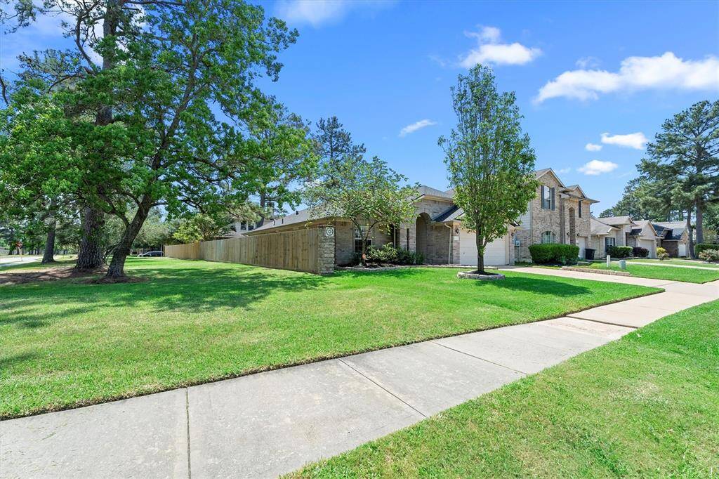 Wide shot showing green space to left of home.