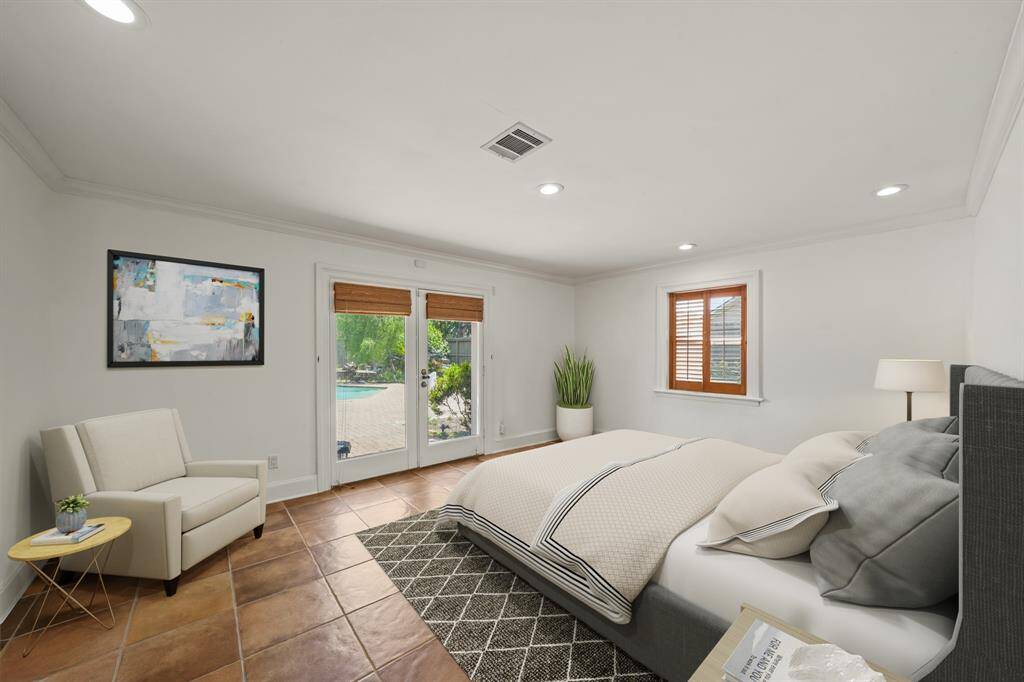 Virtually Staged: Beautiful secondary bedroom highlighting tile flooring, crown molding, recessed lighting, and a stunning view of the pool.