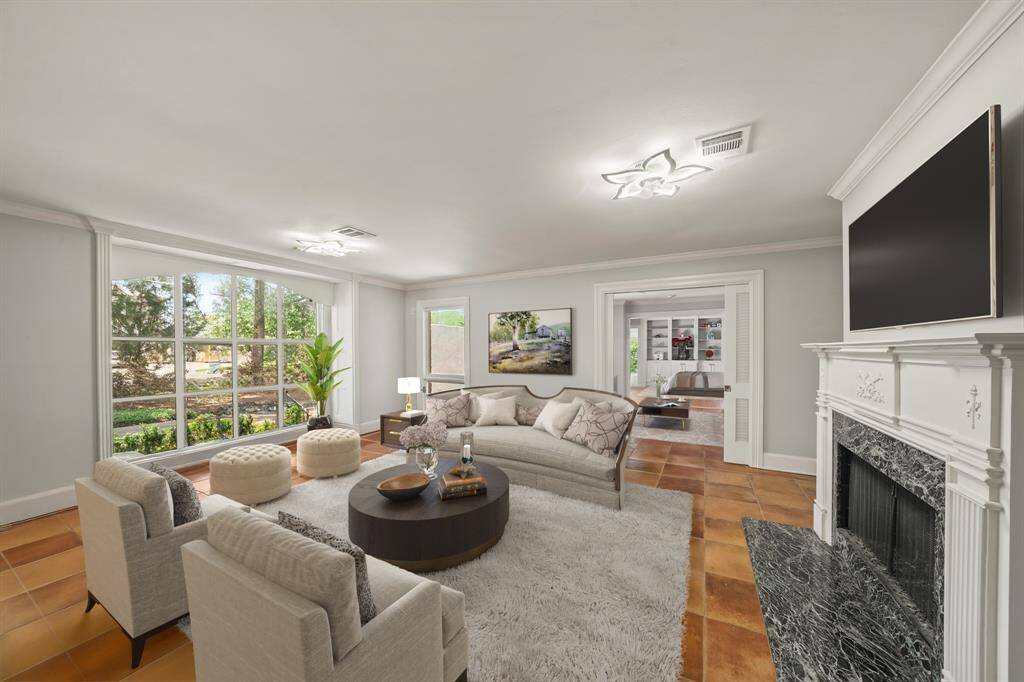 Virtually Staged: This gorgeous living room features beautiful tile floors, a cozy fireplace to keep you warm, and plenty of natural light through the large window.