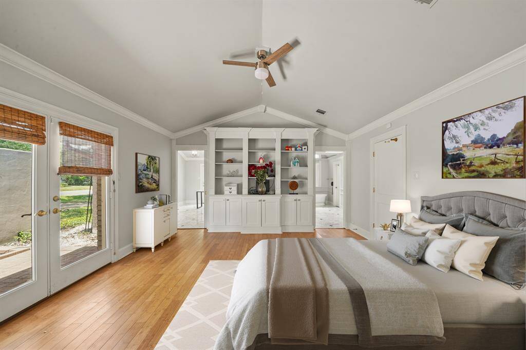 Virtually Staged: This magnificent master suite features wood look tile floors, vaulted ceilings, a ceiling fan, and an amazing view of your atrium.