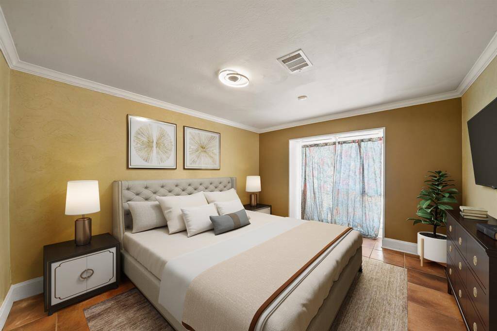 Virtually Staged: This secondary bedroom features tile flooring, crown molding, and a large window.