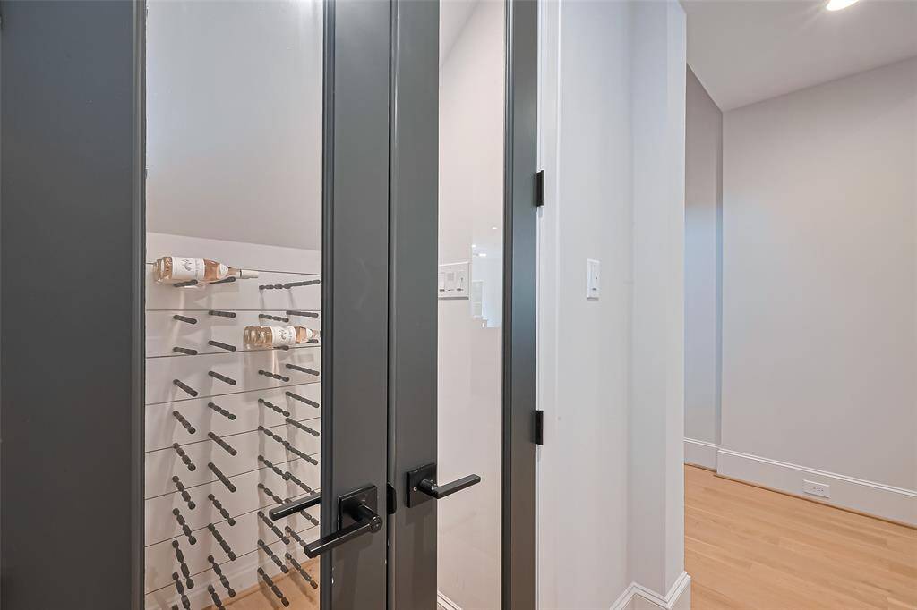 This home features a wine room with a capacity for 400 bottles, conveniently situated near the living room. Please note that the wine room is not climate-controlled.