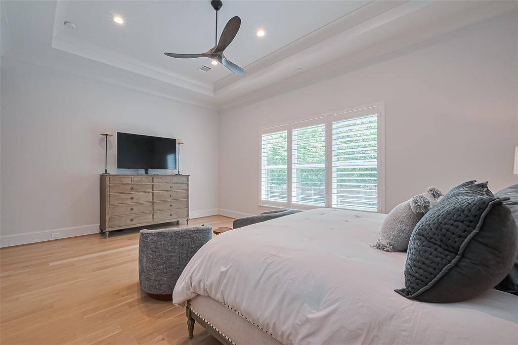 An additional perspective of the generous primary bedroom showcases its ample space and inviting ambiance.