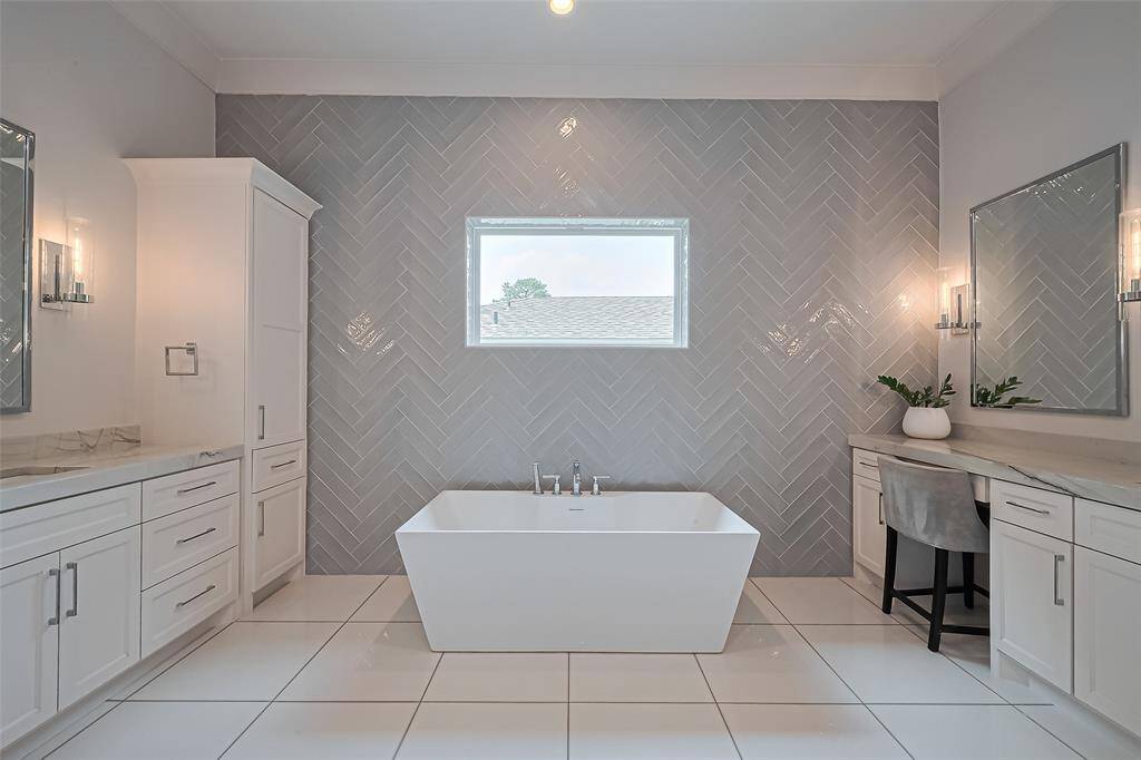 The spacious primary bathroom boasts Quartz countertops, custom cabinetry, and a sought-after double vanity with ample storage, all bathed in natural light. Throughout the home, you'll discover stylish Restoration Hardware lighting, mirrors, and cabinetry.