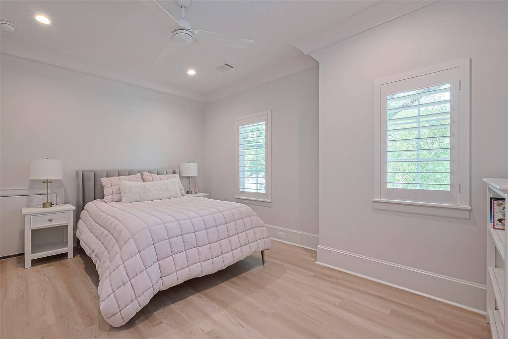 The fourth bedroom, situated upstairs, includes a walk-in closet and an ensuite bathroom.