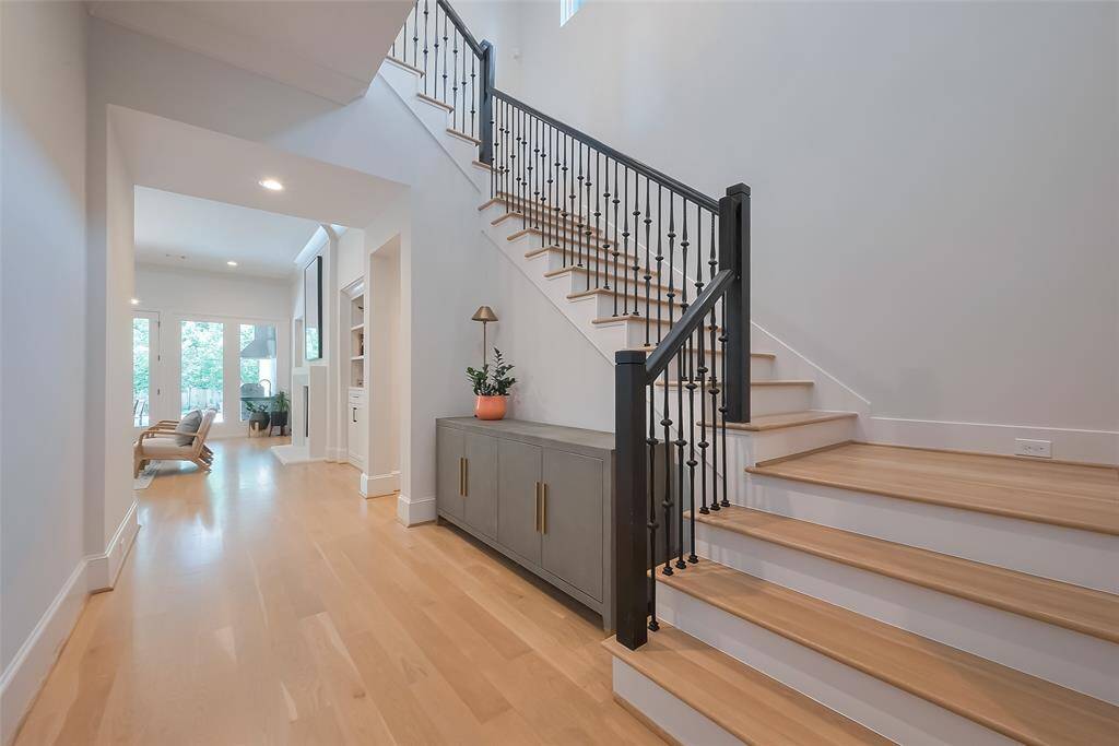 As you step into the property, you'll be welcomed by a stunning foyer that flows seamlessly into the living area. Gorgeous white oak floors grace the entire first level.