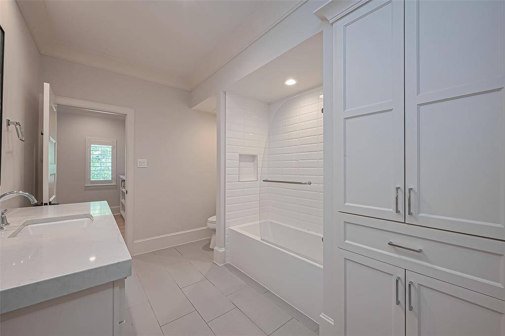 Ensuite bathroom for the fourth bedroom. Solid Surface countertops.