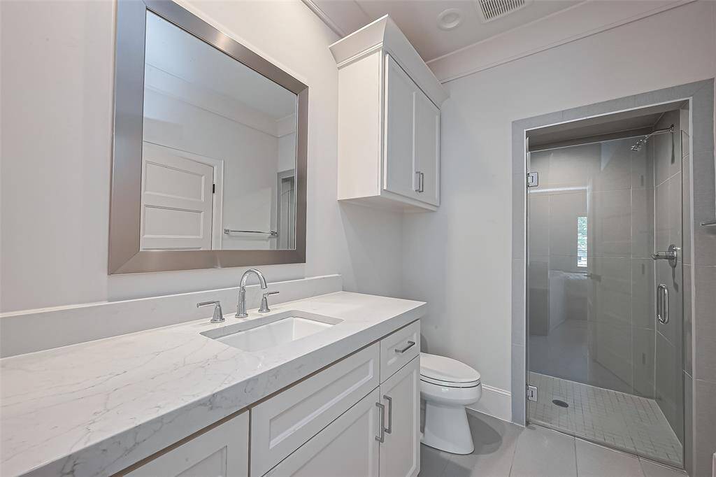Ensuite bathroom for the fifth bedroom.Solid Surface countertops.