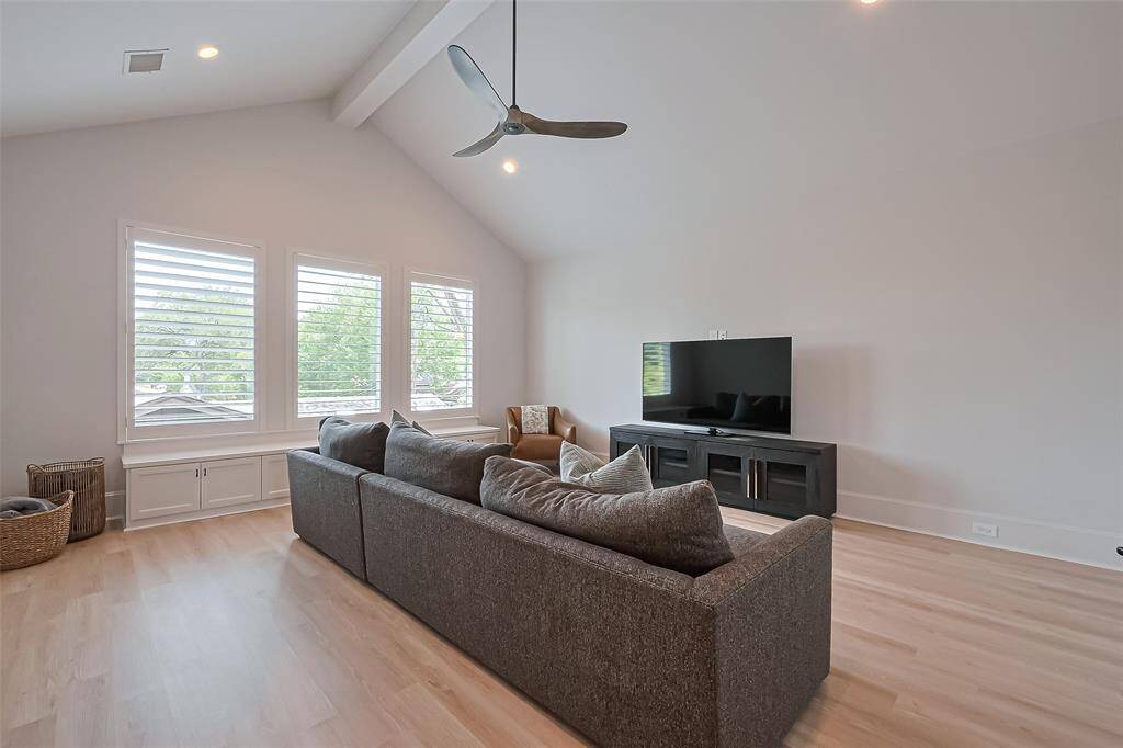 The upstairs game room offers ample space and serves as an ideal gathering spot, featuring bright windows and plenty of room for seating and study areas.