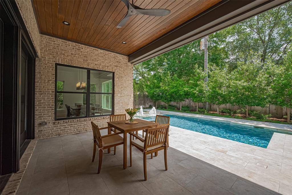 Stunning covered patio featuring a summer kitchen, perfect for entertaining and enjoying summer fun this year.