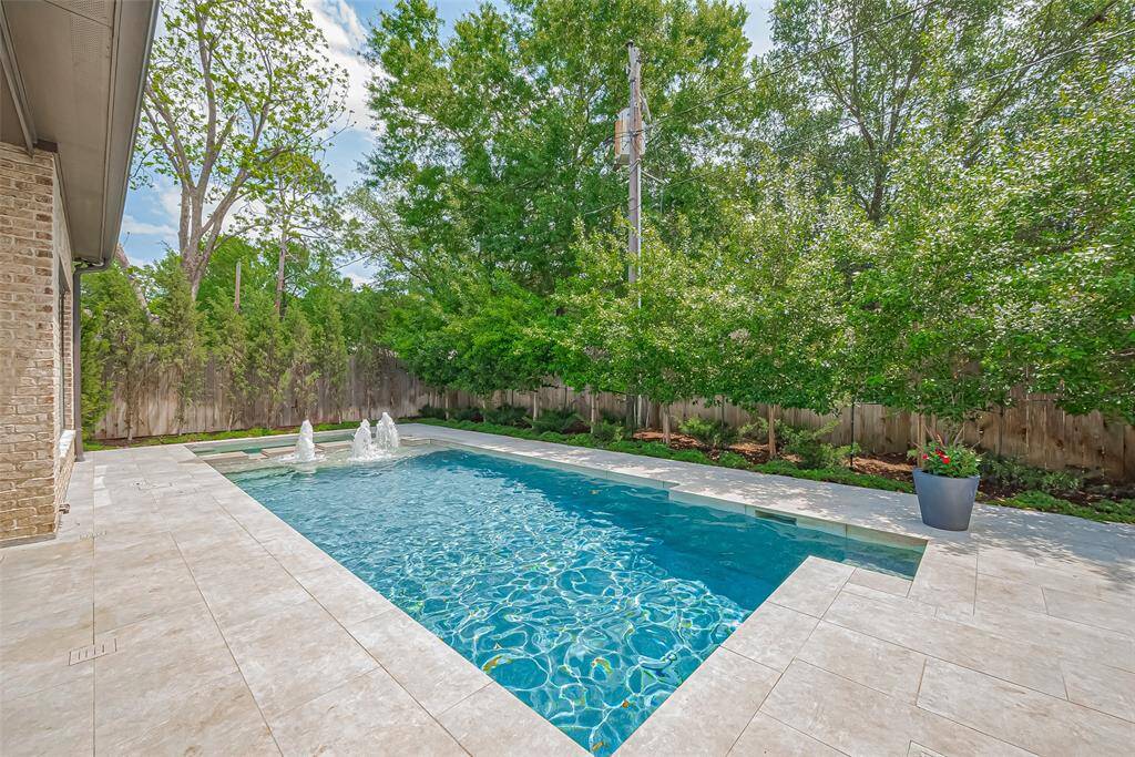 A contemporary pool showcasing a state-of-art in floor cleaning system and a spacious spa, built in 2021.