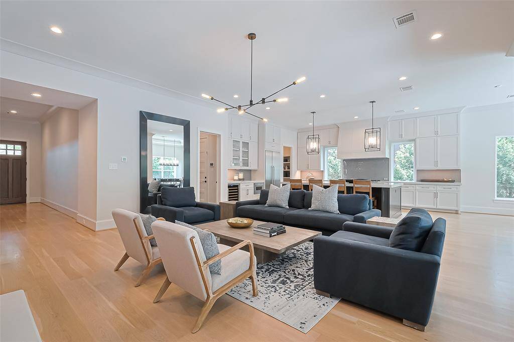 This view from the living room highlights the entrance of the property and the kitchen. The home also includes a wired speaker system for your entertainment needs.