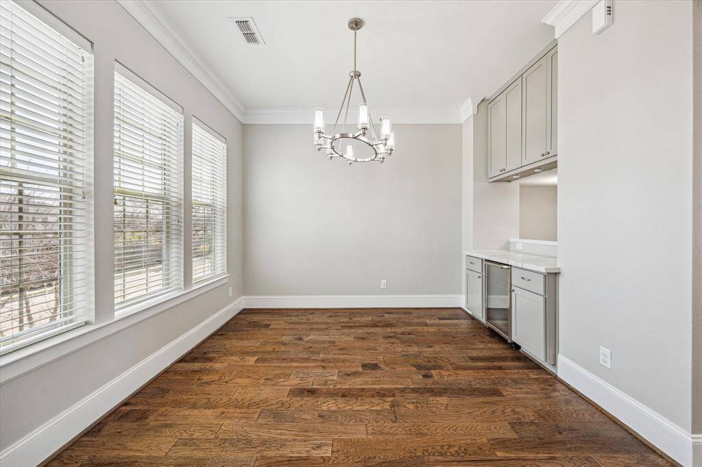 Gather them around your table to honor old traditions and create the new. This elegant dining room offers picture-perfect views, stylish lighting, wood flooring, and a handy serving bar with a beverage chiller and ample storage.