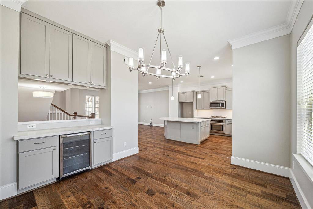 You may be inspired to entertain more often with this elegant dining room, where chic lighting and a dry bar create the perfect space to celebrate any occasion.
