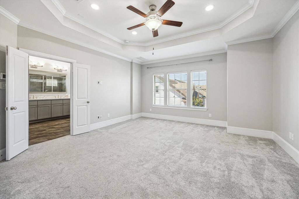 The owner's suite offers neutral carpet and paint, a raised tray ceiling with thick crown molding, recessed lights and a cooling fan. This retreat is complete with a large walk-in closet and a luxurious ensuite bathroom.