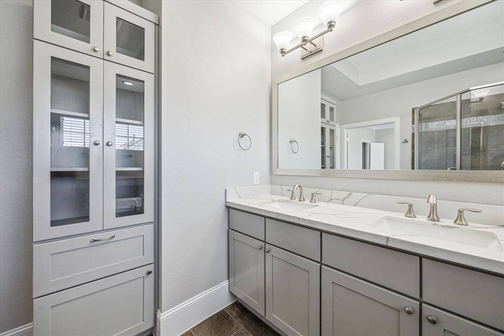 The owner's ensuite has plenty of space for all the necessities with an extended dual sink vanity and custom linen storage.