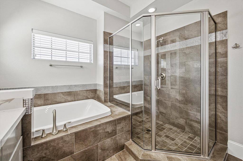 Relax and soak your worries away in this luxurious soaking tub or enjoy a quick rinse in the spacious walk-in shower. Either way, you'll love this private retreat.