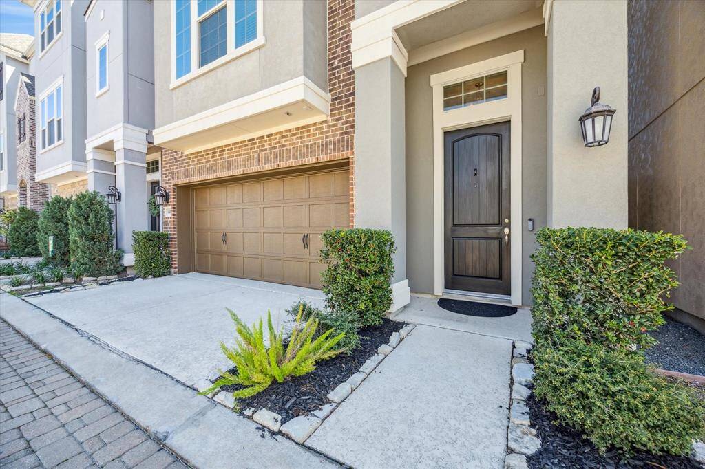 Be welcomed home by outstanding curb appeal, featuring mature landscaping, a sleek modern elevation, a stylish garage door, and elegant exterior lighting. The impressive entry sets the tone for the comfort and style found throughout the home.