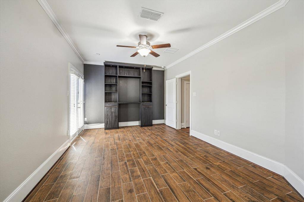 This versatile first-floor suite offers wood-look tile flooring, neutral pant, neutral and designer paint, custom shelving, a large closet, ensuite access to the back patio, and ensuite access to a private bathroom.