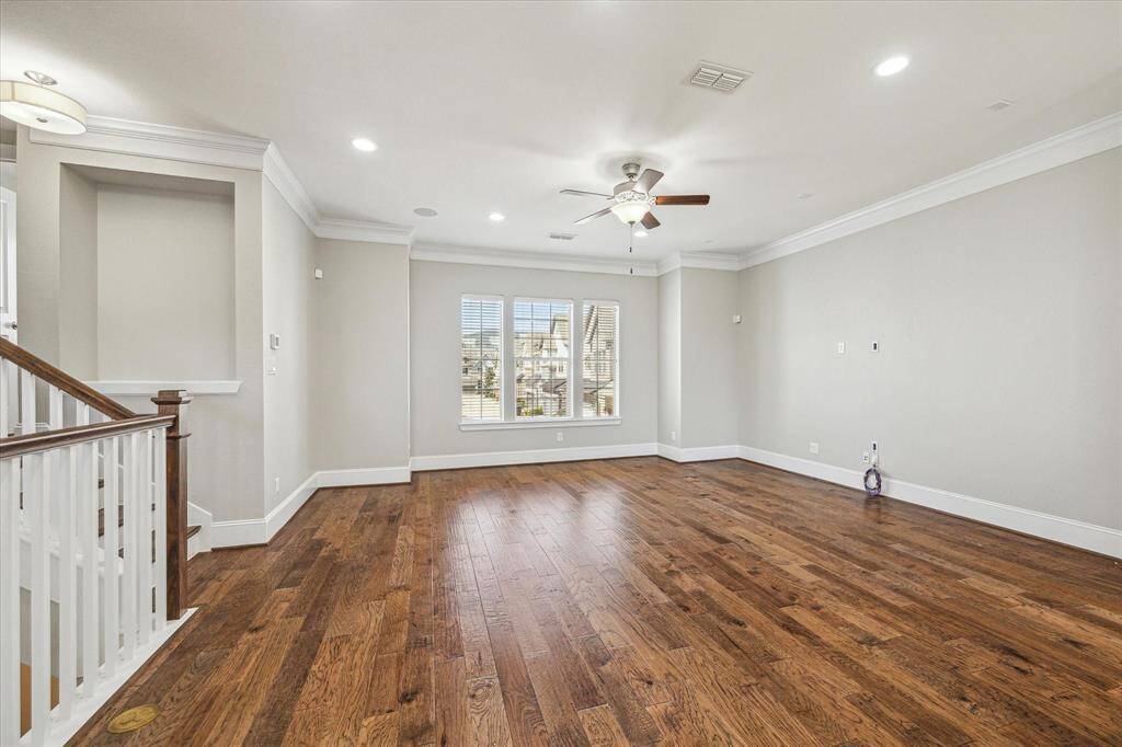 This inviting family room is the perfect place to gather with loved ones or unwind in peaceful solitude. Featuring stunning hardwood flooring, elegant crown molding and thick baseboards, recessed lighting, and built-in ceiling speakers, this space is designed for both comfort and style. Picture-perfect views complete the scene, making it a beautiful and welcoming retreat.