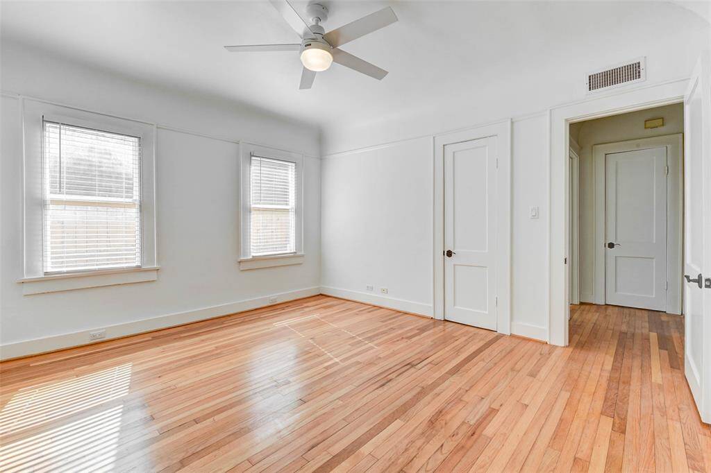 View from back sorner of bedroom shows in room closet with door open to hallway