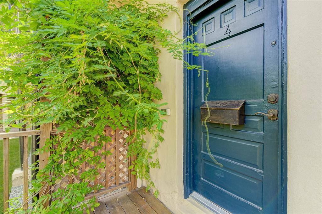 Wisteria covered trellis greets you at the door