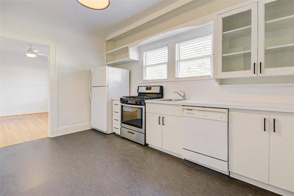 Large, bright, open kitchen with new floor and plenty of storage.