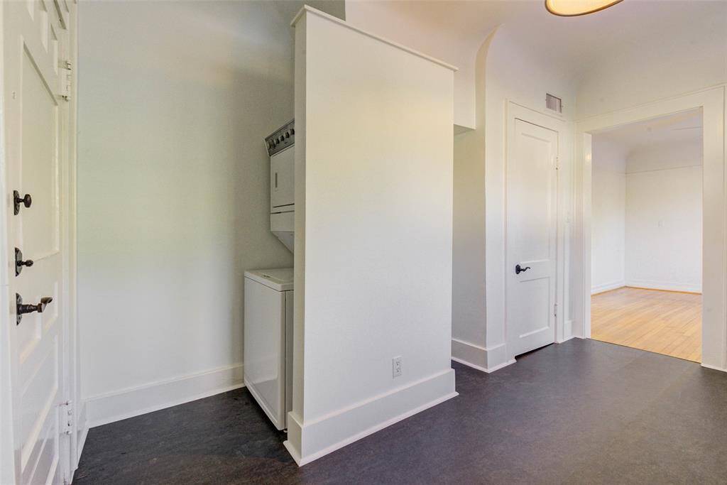 Opposite side of kitchen has space for your own shelving as well as in unit stackedwasher/dryer