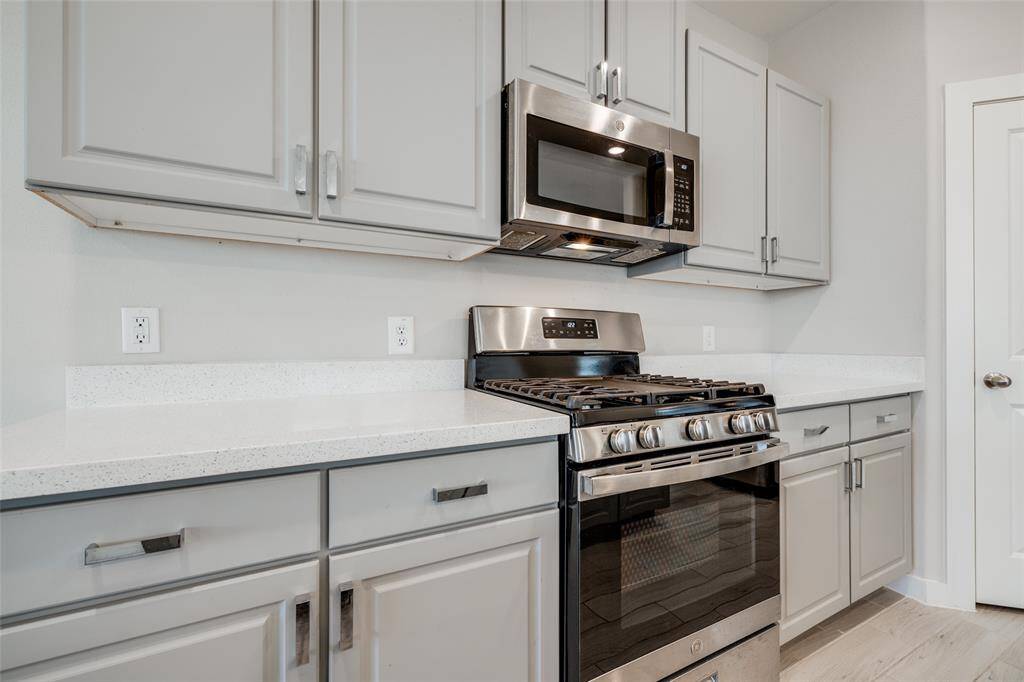 Sleek gas range with built-in microwave and plenty of counter space—perfect for cooking at home.
