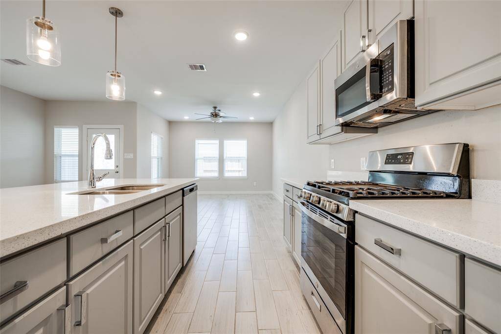 Kitchen flows beautifully into dining and living space—feels fresh and like new with plenty of natural light and clean sightlines throughout.