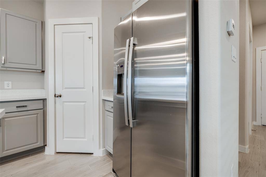 Walk-in pantry and stainless steel fridge offer style and function.