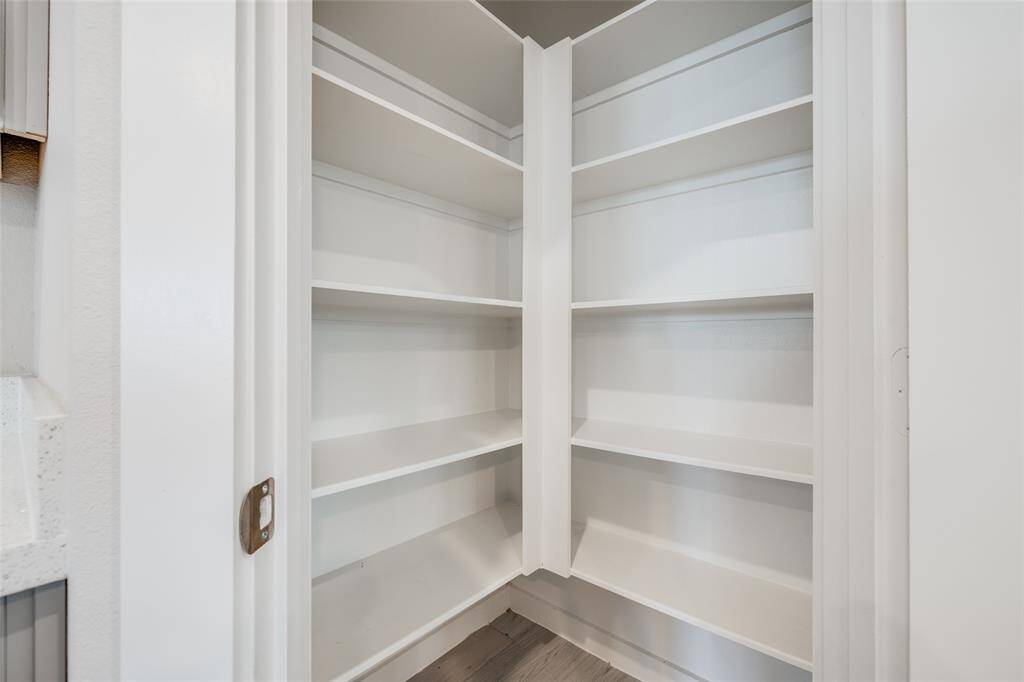 Spacious walk-in pantry with built-in shelving for easy organization.