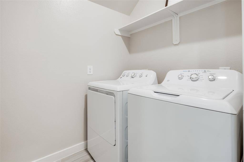 Dedicated laundry room with built-in shelf—washer & dryer included in the lease.