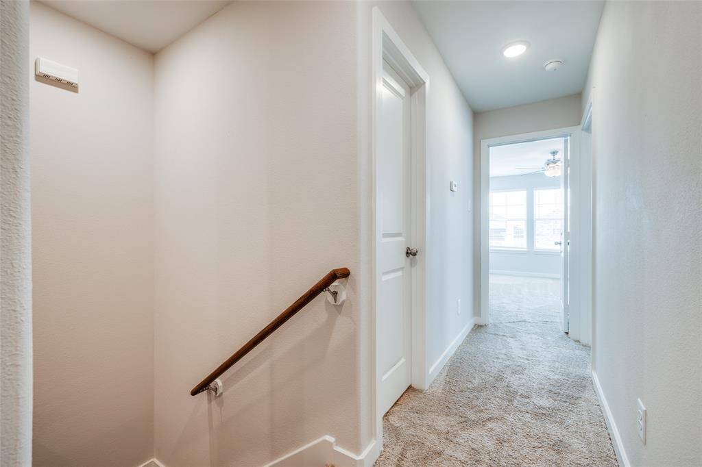 Upstairs hallway leads to bedrooms and a sun-filled bonus space.
