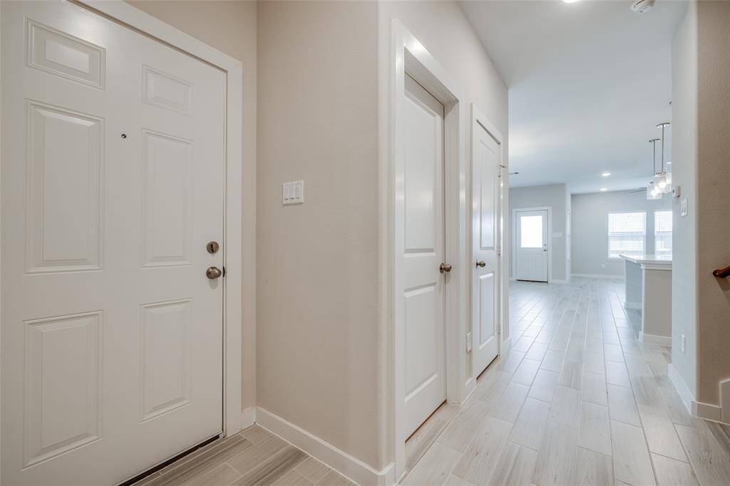 Bright entry with coat closet and tall ceilings.