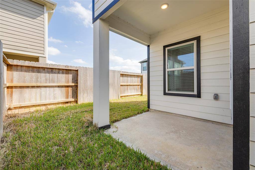 Covered patio with just enough yard space for a garden, grill, or a morning coffee setup—peaceful and private.