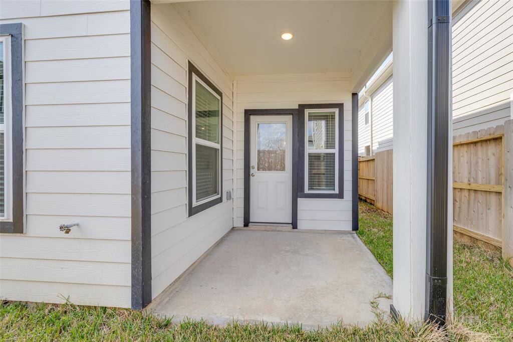 Rear view of home with private, fenced backyard.