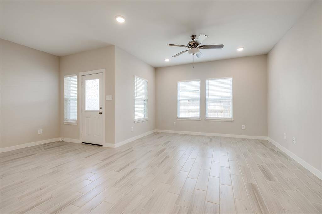 Spacious living room with backyard access, flexible layout for seating or media setup—lightly lived-in with a clean, modern feel that feels fresh and like new.