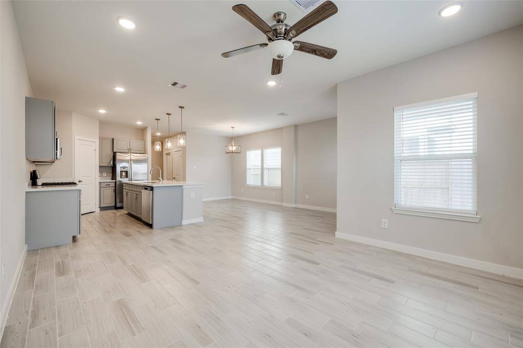 Expansive open-plan living, dining, and kitchen area—perfect for entertaining or relaxing in a space that feels fresh and like new.