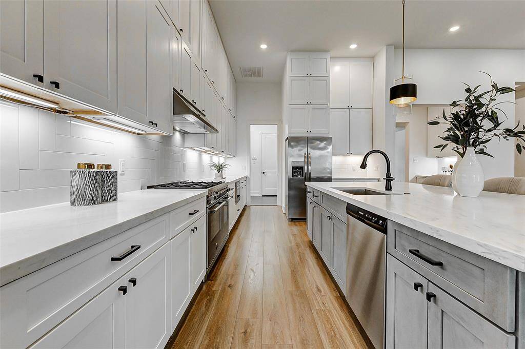 Adjacent to the fridge, additional cabinetry provides even more storage, enhancing the kitchen's functionality.