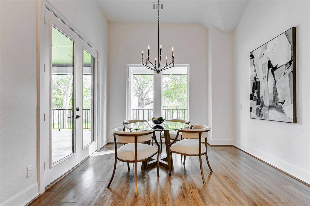 Just off the kitchen, you'll discover this charming breakfast area, bathed in natural light and surrounded by windows, offering a serene spot to start your day.