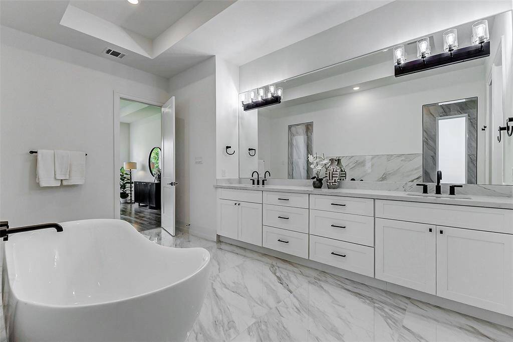 The expansive counters and under-cabinet storage offer abundant space for all your toiletries, makeup, and other essentials, ensuring the bathroom remains both stylish and highly functional.