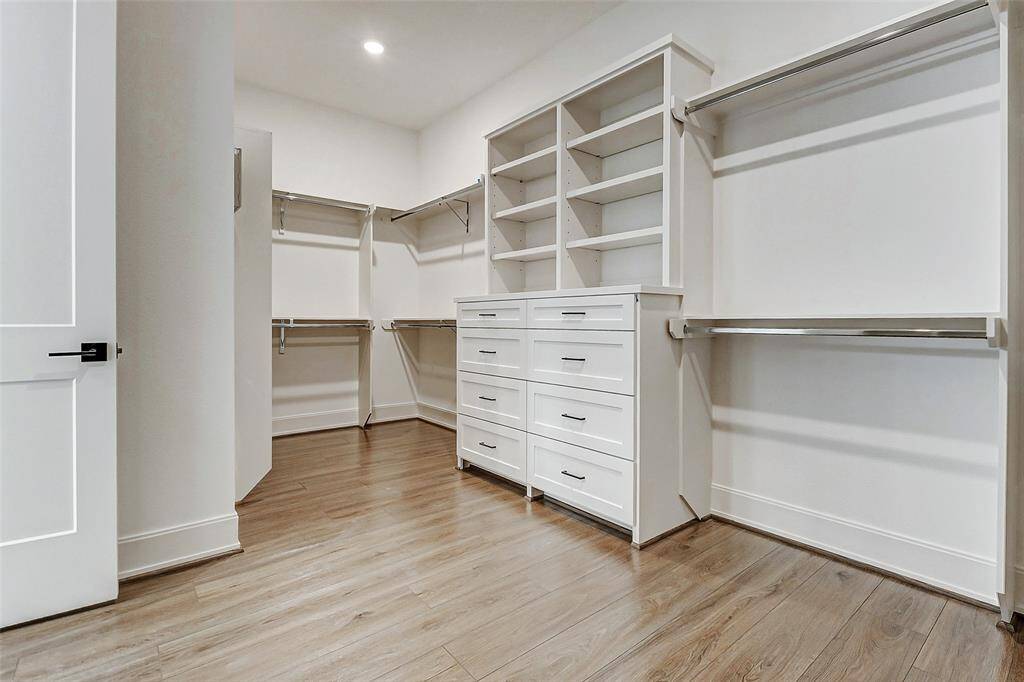 Welcome to your dream closet! This meticulously designed closet system features built-in drawers, shelving, and hanging racks, offering both organization and elegance for all your wardrobe essentials.