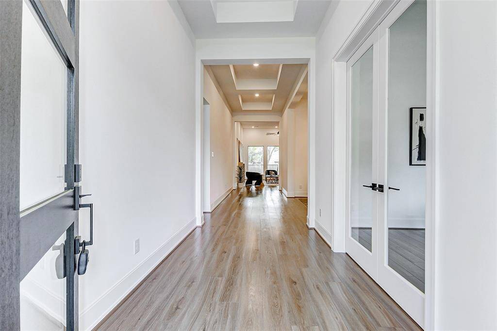 Welcome home! Step inside to a stunning front foyer adorned with stunning luxury vinyl plank floors, designer paint tones, soaring ceilings, and an abundance of natural light that sets the tone for the rest of this beautifully appointed residence.